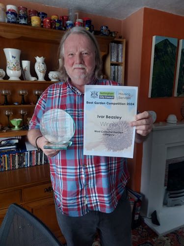 Most colourful garden category winner Ivor Beasley holding his certificate and trophy