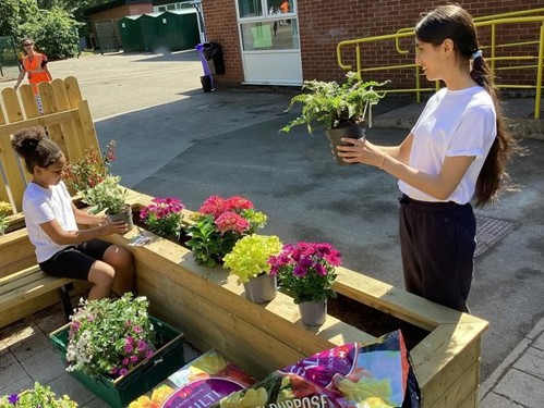 Picture of two pupils at Huntingdon Academy looking after their school garden - the winning garden in the Best Young Gardener category